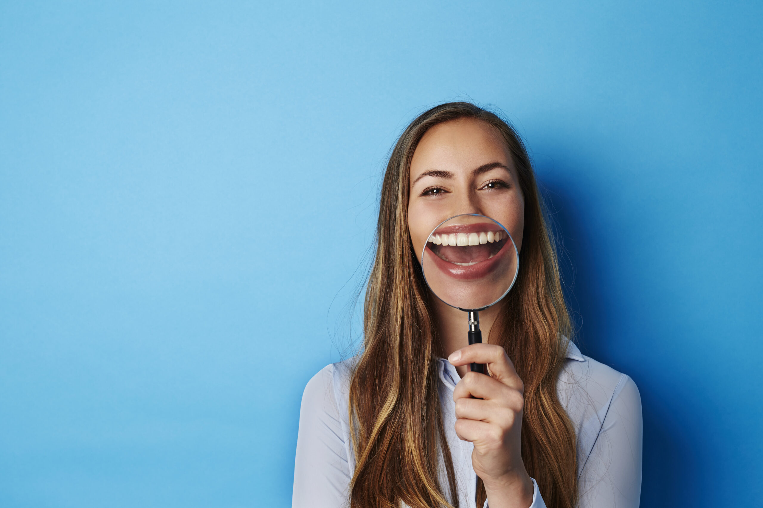 Smiling woman against a blue background